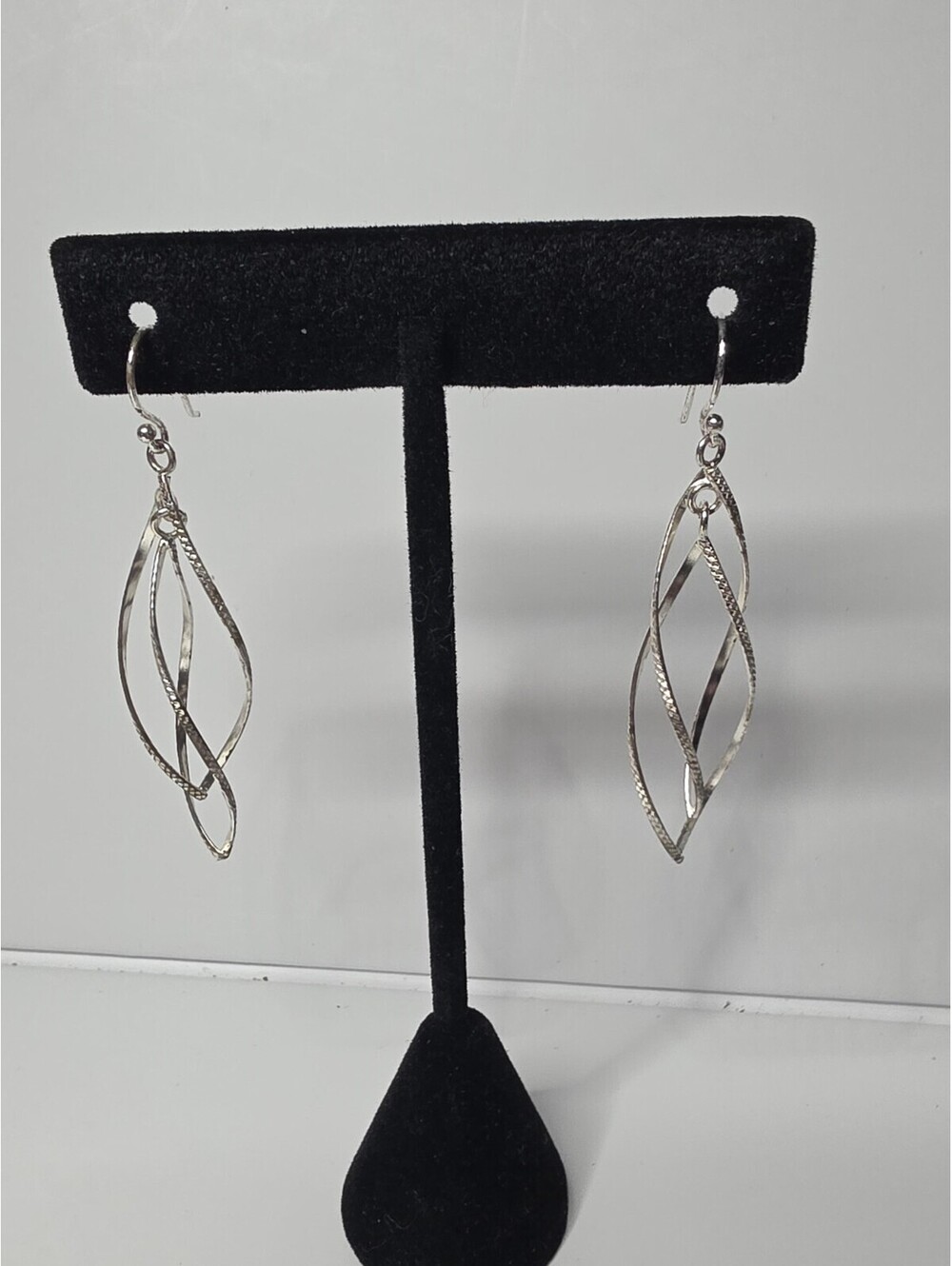 Sterling Silver Twisted Oval Dangle Earrings featuring a Diamond Cut finish